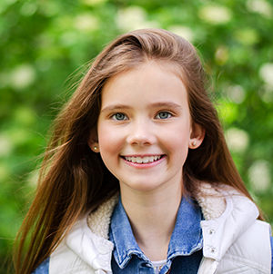 young girl smiling outside