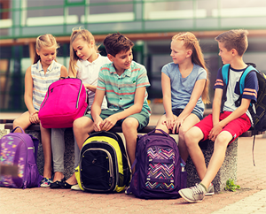 students with backpacks outside